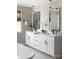 Bathroom with double vanity, frameless mirrors, and marble backsplash at Lot 42 Watercourse Way # Hawthorne, Belmont, NC 28012