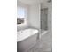 Bathroom with a freestanding tub and a large, bright window at Lot 42 Watercourse Way # Hawthorne, Belmont, NC 28012
