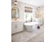 Elegant bathroom with marble tile, freestanding tub, and dual vanities at Lot 42 Watercourse Way # Hawthorne, Belmont, NC 28012