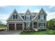 Two-story house with gray siding, stone accents, and a two-car garage at Lot 42 Watercourse Way # Hawthorne, Belmont, NC 28012