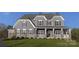 Two-story home with gray siding, stone accents, and a front porch at Lot 41 Rivermist Dr # Hawthorne, Belmont, NC 28012