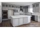 Modern kitchen with gray cabinets, marble island, and stainless steel appliances at Lot 42 Watercourse Way # Hawthorne, Belmont, NC 28012
