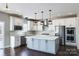 Spacious kitchen featuring white cabinets, a large island, and stainless steel appliances at Lot 42 Watercourse Way # Hawthorne, Belmont, NC 28012