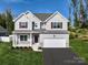 Two story home with gray siding, maroon shutters, and a landscaped lawn at Lot 41 Watercourse Way # Savanh, Belmont, NC 28012