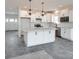 White kitchen with large island, granite countertops, and gray tile floor at Lot 41 Watercourse Way # Savanh, Belmont, NC 28012