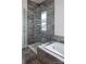 Modern bathroom featuring a walk-in shower with glass enclosure and a soaking tub at Lot 51 Rivermist Dr # Arcadia, Belmont, NC 28012