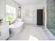 Modern bathroom with a freestanding tub and marble tile at Lot 51 Watercourse Way # Covington, Belmont, NC 28012