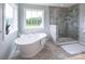Modern bathroom with a soaking tub, walk-in shower, and a window with a view at Lot 51 Watercourse Way # Covington, Belmont, NC 28012