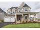 Two-story home with stone and beige siding, and a two-car garage at Lot 51 Watercourse Way # Covington, Belmont, NC 28012