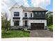 Two-story farmhouse with white siding, dark gray accents, and a two-car garage at Lot 51 Watercourse Way # Covington, Belmont, NC 28012