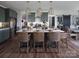 Modern kitchen featuring a large island with seating and stylish cabinetry at Lot 51 Watercourse Way # Covington, Belmont, NC 28012