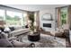 Bright living room with white brick fireplace, large windows, and comfortable seating at Lot 51 Watercourse Way # Covington, Belmont, NC 28012