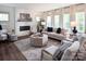 Cozy living room with white brick fireplace, hardwood floors, and comfortable seating at Lot 51 Watercourse Way # Covington, Belmont, NC 28012