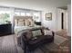 Luxurious main bedroom with a king-size bed and sitting area at Lot 51 Watercourse Way # Covington, Belmont, NC 28012