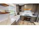 Kitchen with farmhouse sink and wood shelving at 128 Wickford Ln, Mooresville, NC 28117