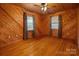 Simple bedroom with wood walls and hardwood floors at 1622 Ebinport Rd, Rock Hill, SC 29732