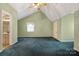 Bright bedroom with teal carpet, ceiling fan, and ensuite bathroom access at 1622 Ebinport Rd, Rock Hill, SC 29732