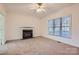 Living room with fireplace, carpet, and ceiling fan at 16822 Laureate Rd, Huntersville, NC 28078