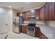 Kitchen with stainless steel appliances, wood cabinetry, and tile flooring at 2023 Aragon Ln, Gastonia, NC 28056