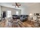 Living area with a large sectional sofa, ceiling fan, and wood-style flooring at 2023 Aragon Ln, Gastonia, NC 28056