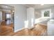 Kitchen with view into living room, white cabinets, and wood flooring at 2222 Moose Rd, Kannapolis, NC 28083