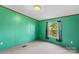 Bedroom with teal walls and a window at 227 Grassy Meadow Ln, Statesville, NC 28625