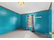 Bright bedroom featuring teal walls and window coverings at 227 Grassy Meadow Ln, Statesville, NC 28625
