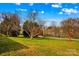 Landscaped yard with trees and driveway at 227 Grassy Meadow Ln, Statesville, NC 28625