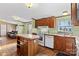 Kitchen with wood cabinets, white appliances, and island at 227 Grassy Meadow Ln, Statesville, NC 28625