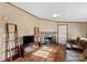 Living room with a stone fireplace, hardwood floors, and a large sectional sofa at 227 Grassy Meadow Ln, Statesville, NC 28625