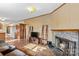 Open living room with hardwood floors, a fireplace, and views to the kitchen at 227 Grassy Meadow Ln, Statesville, NC 28625