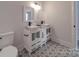 Double vanity bathroom with a white cabinet and patterned floor at 2335 Emanuel Church Rd, Rockwell, NC 28138