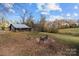 Rustic barn with a fenced area and firepit in the yard at 24694 Saint Martin Rd, Albemarle, NC 28001