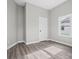 Simple bedroom with grey walls, wood-look vinyl flooring, and a window at 3332 York Hwy, Gastonia, NC 28052