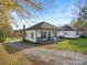 Newly renovated white house with black accents, a porch, and a gravel driveway at 3332 York Hwy, Gastonia, NC 28052