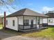 Newly renovated white house with a covered porch, black accents, and a gravel driveway at 3332 York Hwy, Gastonia, NC 28052