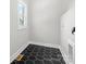 Bright laundry room featuring hexagon floor tile and built-in shelving at 3332 York Hwy, Gastonia, NC 28052