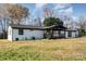 Ranch-style home with a white brick exterior, dark trim, and a covered patio at 3700 Pinecrest Dr, Gastonia, NC 28056