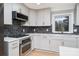 Modern kitchen features gray cabinets, quartz countertops, and stainless steel appliances at 3700 Pinecrest Dr, Gastonia, NC 28056