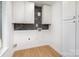 Bright laundry room with white cabinets and dark gray tile backsplash at 3700 Pinecrest Dr, Gastonia, NC 28056