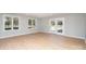 Bright living room featuring light wood floors and multiple windows at 3700 Pinecrest Dr, Gastonia, NC 28056
