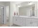 Double vanity bathroom with white cabinets and a separate toilet area at 3950 Rothwood Ln, Harrisburg, NC 28075