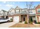 Two-story townhome with brick and siding exterior, two-car garage, and landscaped front yard at 3950 Rothwood Ln, Harrisburg, NC 28075