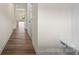 Bright hallway with hardwood floors leading to other rooms at 3950 Rothwood Ln, Harrisburg, NC 28075