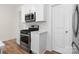 Modern kitchen with stainless steel appliances and white cabinetry at 3950 Rothwood Ln, Harrisburg, NC 28075