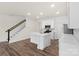 Modern kitchen with white cabinets, island, and stainless steel appliances at 3950 Rothwood Ln, Harrisburg, NC 28075