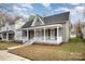 Gray house with white columns and a wrap around porch at 409 S Rowan Ave, Spencer, NC 28159