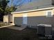 Rear of house, tan siding, stone path, and AC unit at 427 E Cemetery St, Salisbury, NC 28144