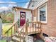 Charming back porch with wooden steps and a wreath at 4356 Charles Raper Jonas Hwy, Alexis, NC 28006