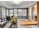 Bright sunroom featuring comfortable seating and backyard access at 4356 Charles Raper Jonas Hwy, Alexis, NC 28006